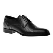 Lace-ups in black perforated calfskin